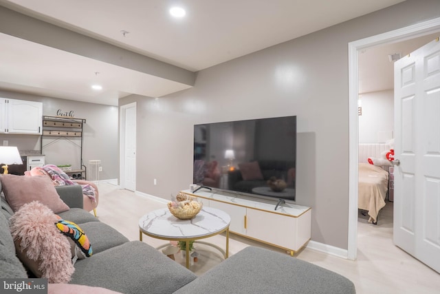 living area with recessed lighting and baseboards