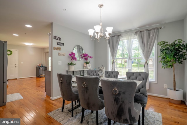 dining room featuring a chandelier, light wood-style flooring, baseboards, and recessed lighting