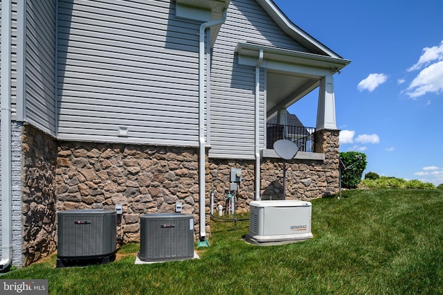 1760 Florence Rd, Mount Airy, MD 21771 - view of property exterior with central AC unit, stone siding, and a yard