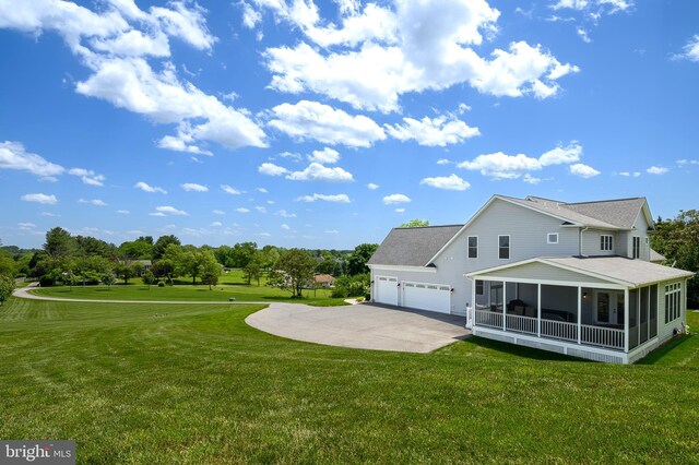 1760 Florence Rd, Mount Airy, MD 21771 - rear view of house with an attached garage, a sunroom, concrete driveway, and a lawn