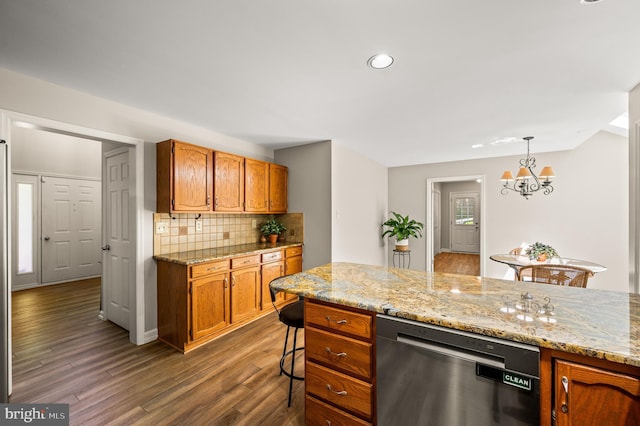 kitchen featuring dishwasher, decorative backsplash, a chandelier, wood finished floors, and recessed lighting