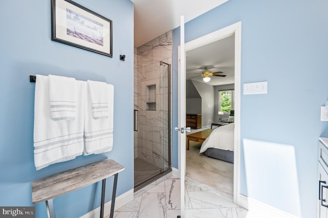 ensuite bathroom featuring marble finish floors, a shower stall, baseboards, and a ceiling fan