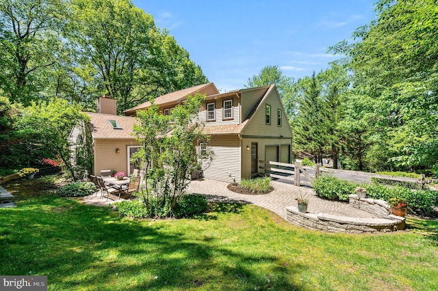 rear view of house featuring a patio area and a shingled roof