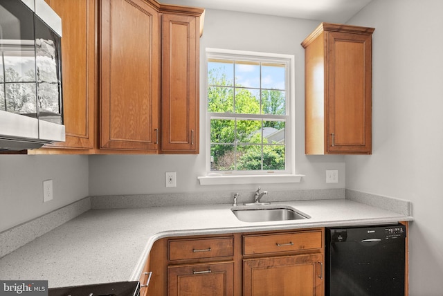 kitchen with dishwasher, a sink, light countertops, and stainless steel microwave