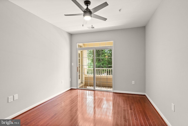unfurnished room featuring wood-type flooring, ceiling fan, baseboards, and a pendent fire sprinkler