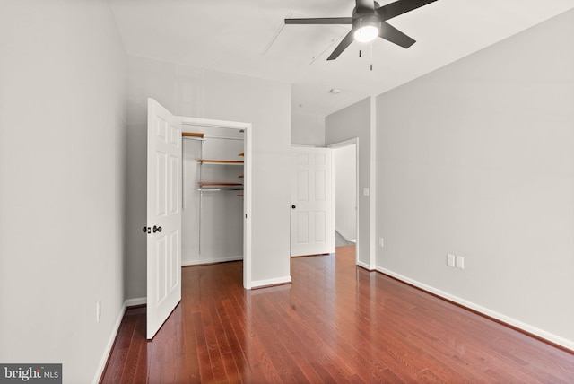 unfurnished bedroom with hardwood / wood-style flooring, baseboards, a closet, and a ceiling fan