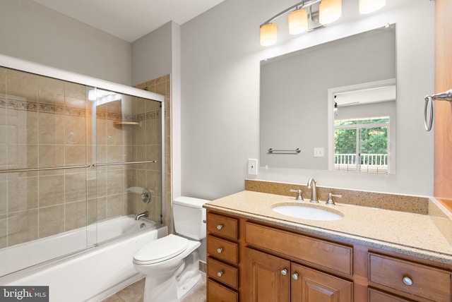 full bathroom featuring toilet, vanity, enclosed tub / shower combo, and tile patterned floors