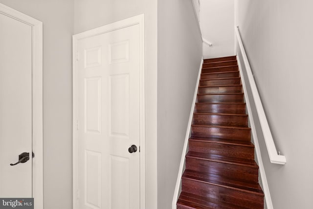staircase featuring baseboards