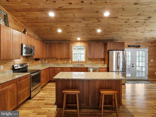 79 Whiskey Still Rd, Berkeley Springs, WV 25411 - kitchen featuring stainless steel appliances, a sink, wood ceiling, a kitchen breakfast bar, and light wood-style flooring