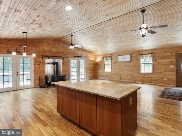 79 Whiskey Still Rd, Berkeley Springs, WV 25411 - kitchen with french doors, open floor plan, ceiling fan, wooden walls, and light wood-type flooring