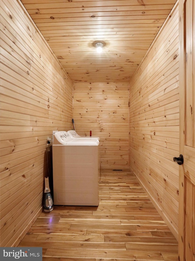 79 Whiskey Still Rd, Berkeley Springs, WV 25411 - laundry room featuring washing machine and clothes dryer, wood ceiling, wood walls, a relaxing sauna, and light wood-style flooring