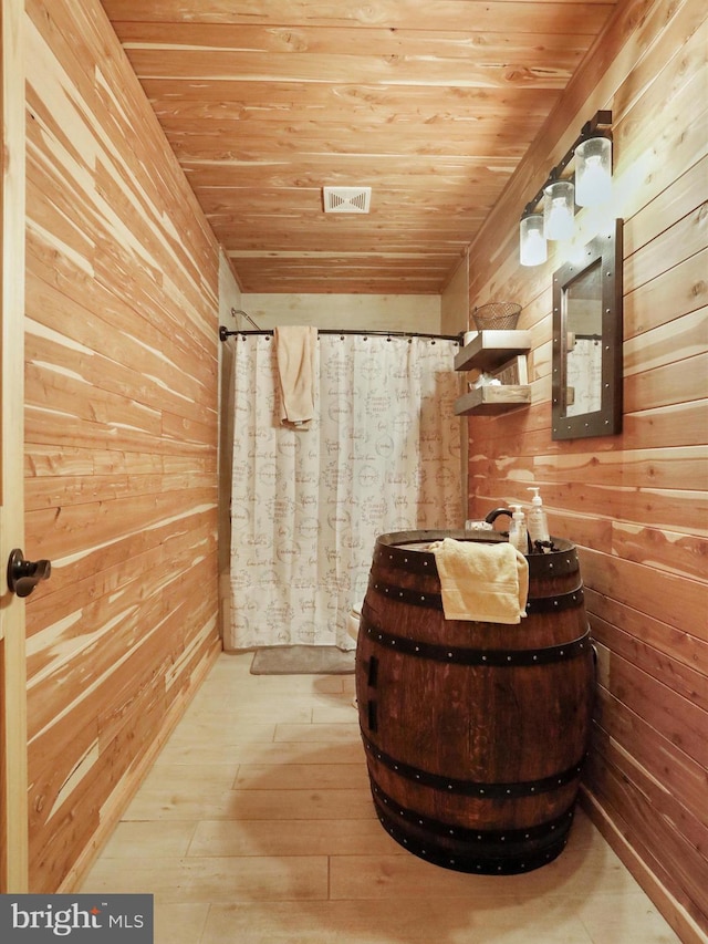79 Whiskey Still Rd, Berkeley Springs, WV 25411 - full bathroom with wooden walls, wood ceiling, wood-type flooring, and a shower with curtain