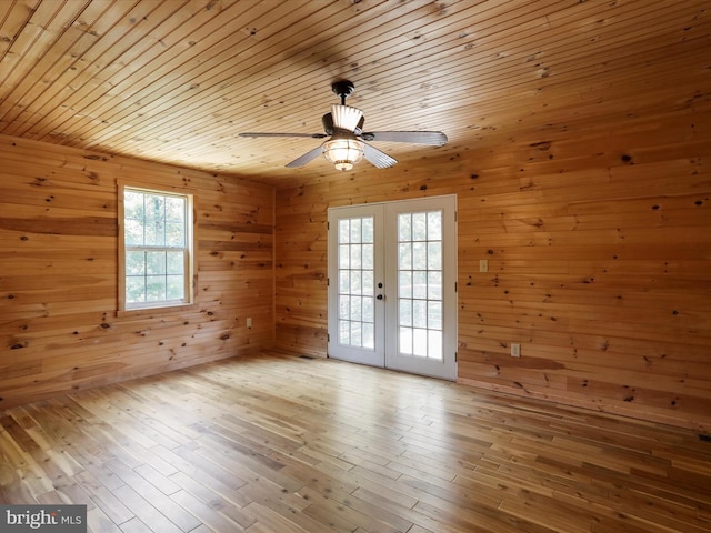 79 Whiskey Still Rd, Berkeley Springs, WV 25411 - spare room featuring french doors, wooden walls, ceiling fan, wooden ceiling, and hardwood / wood-style floors