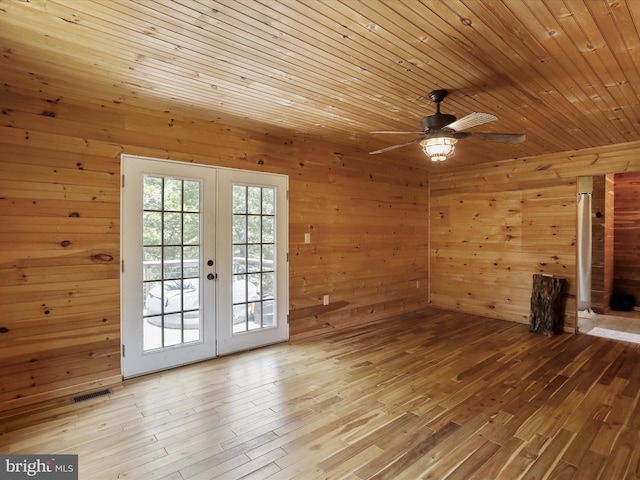 79 Whiskey Still Rd, Berkeley Springs, WV 25411 - unfurnished living room featuring french doors, wood walls, wood-type flooring, a ceiling fan, and wooden ceiling