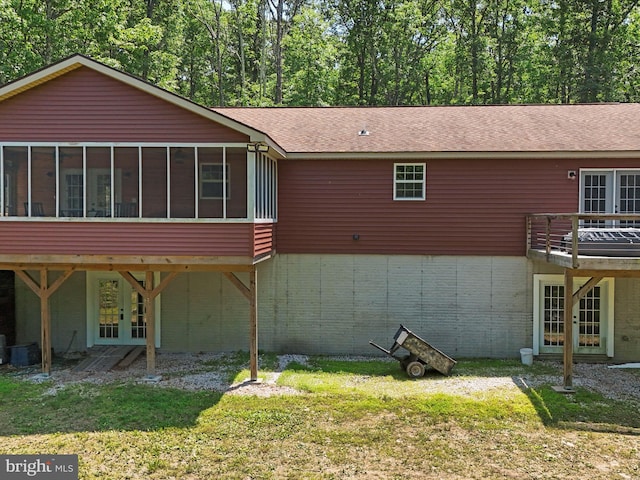 79 Whiskey Still Rd, Berkeley Springs, WV 25411 - rear view of property featuring a sunroom, a shingled roof, french doors, and a lawn
