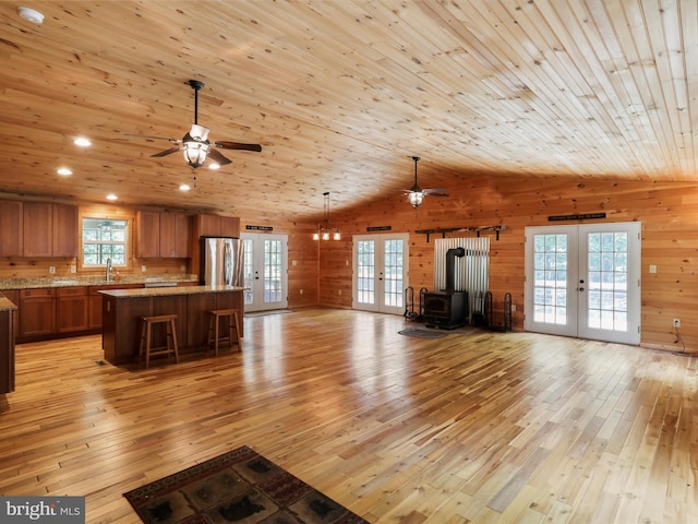 79 Whiskey Still Rd, Berkeley Springs, WV 25411 - unfurnished living room featuring french doors, ceiling fan, light wood-style flooring, wooden walls, and recessed lighting