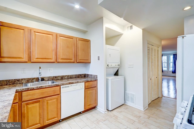 1307 Emerald St NE, Washington, DC 20002 - kitchen with white appliances, a sink, stacked washer / dryer, light wood-style floors, and recessed lighting