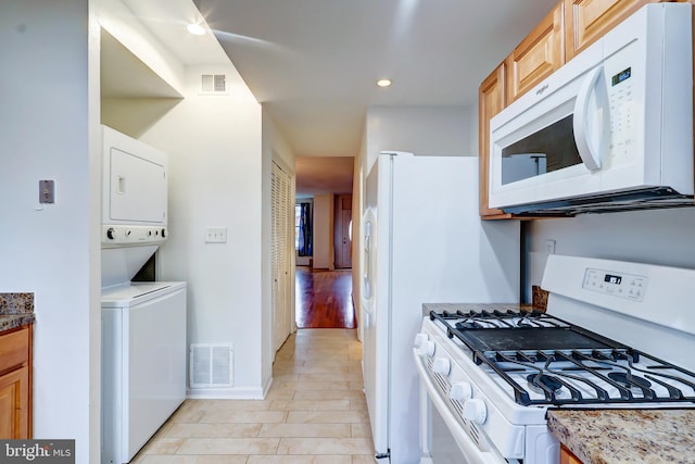 1307 Emerald St NE, Washington, DC 20002 - kitchen featuring white appliances, estacked washer and dryer, recessed lighting, stone countertops, and baseboards