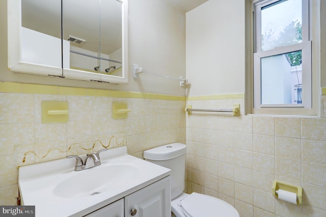 1307 Emerald St NE, Washington, DC 20002 - bathroom with toilet, vanity, tile walls, and a wainscoted wall