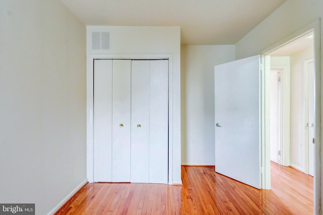 1307 Emerald St NE, Washington, DC 20002 - unfurnished bedroom featuring light wood-type flooring, a closet, and baseboards