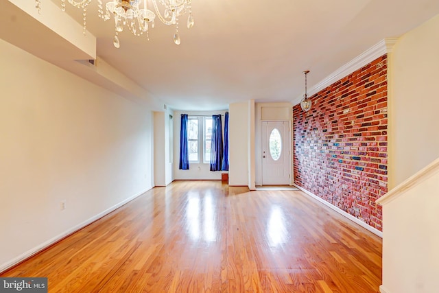 1307 Emerald St NE, Washington, DC 20002 - entrance foyer featuring a chandelier, light wood finished floors, baseboards, and brick wall