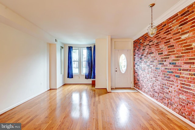 1307 Emerald St NE, Washington, DC 20002 - foyer entrance featuring brick wall, light wood-style flooring, and baseboards