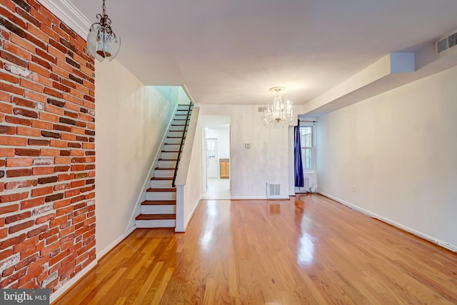 1307 Emerald St NE, Washington, DC 20002 - unfurnished living room with a chandelier, wood finished floors, stairs, and baseboards