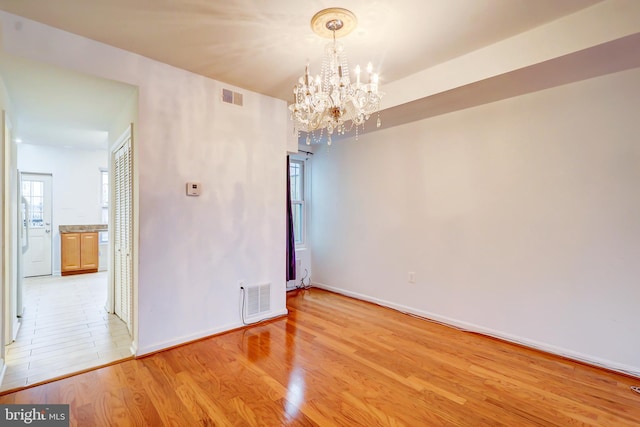 1307 Emerald St NE, Washington, DC 20002 - unfurnished room with a chandelier, light wood finished floors, and baseboards