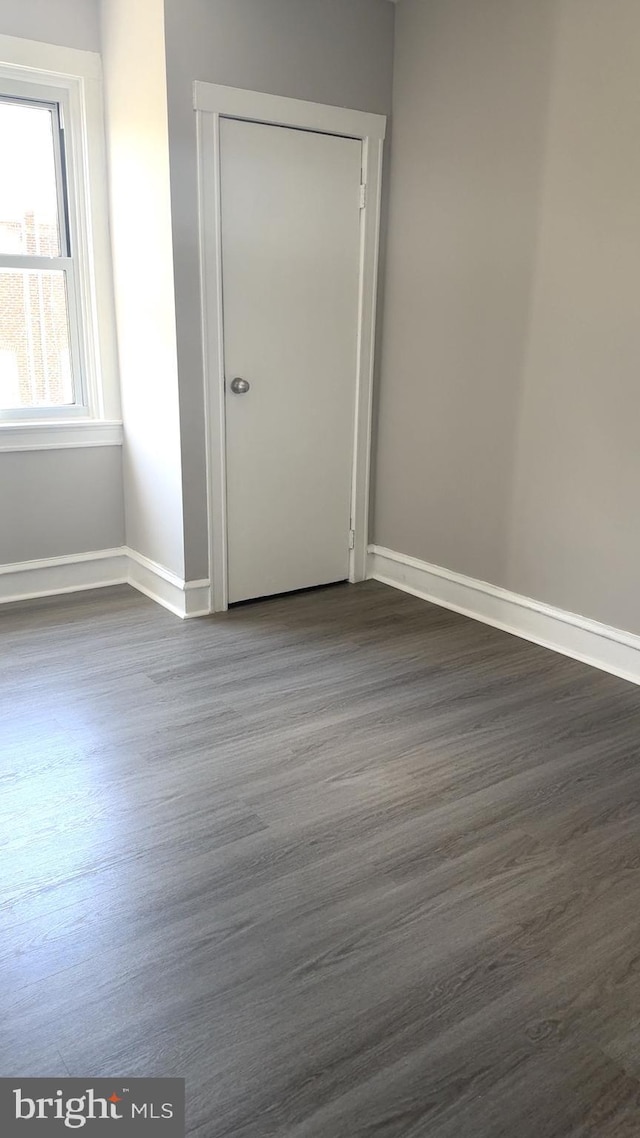 6529 Vandike St, Philadelphia, PA 19135 - unfurnished room with dark wood finished floors and baseboards