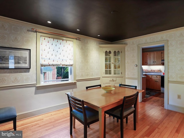 210 W 1st St, Front Royal, VA 22630 - dining room with wallpapered walls, light wood-type flooring, ornamental molding, and baseboards