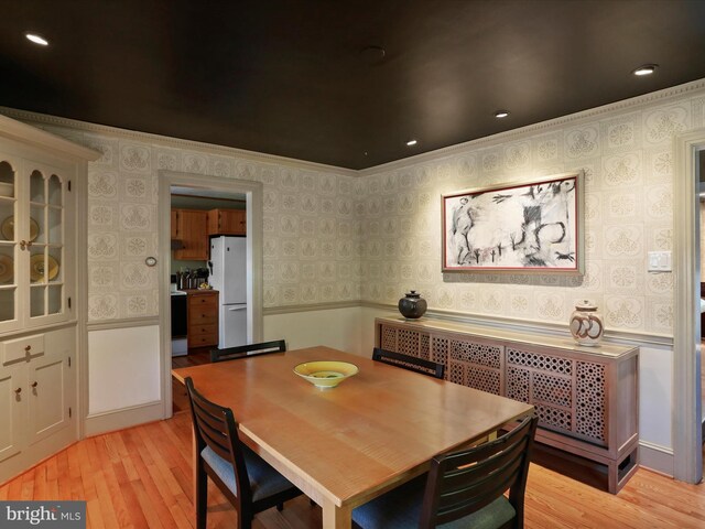 210 W 1st St, Front Royal, VA 22630 - dining room with wallpapered walls, light wood-style flooring, crown molding, and wainscoting