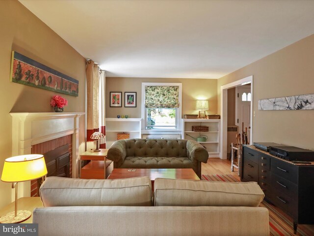 210 W 1st St, Front Royal, VA 22630 - living room with a brick fireplace and wood finished floors