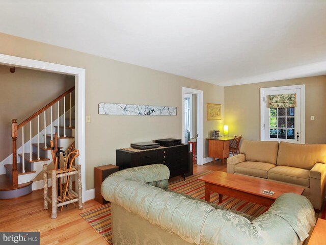 210 W 1st St, Front Royal, VA 22630 - living room featuring light wood-style flooring, stairs, and baseboards