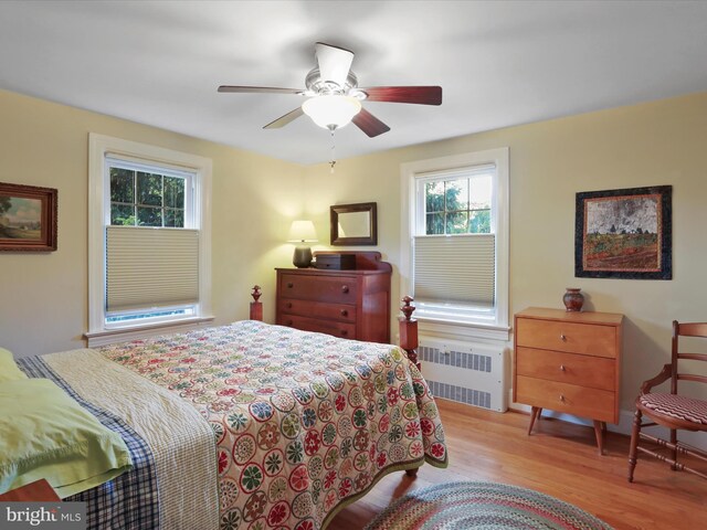 210 W 1st St, Front Royal, VA 22630 - bedroom featuring radiator, wood finished floors, and a ceiling fan