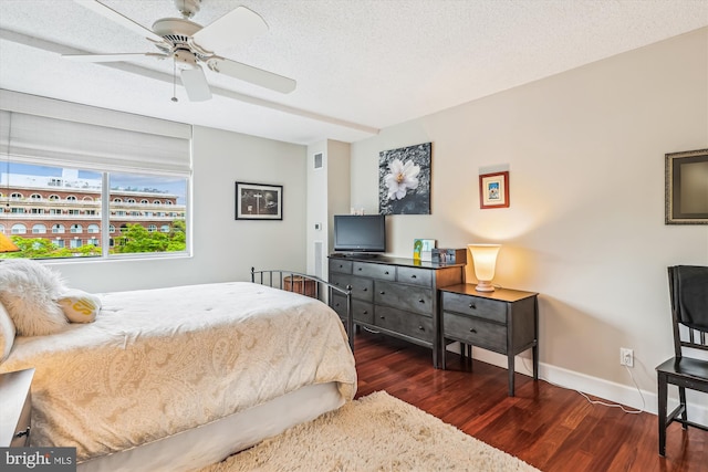 bedroom featuring wood finished floors, baseboards, ceiling fan, and a textured ceiling