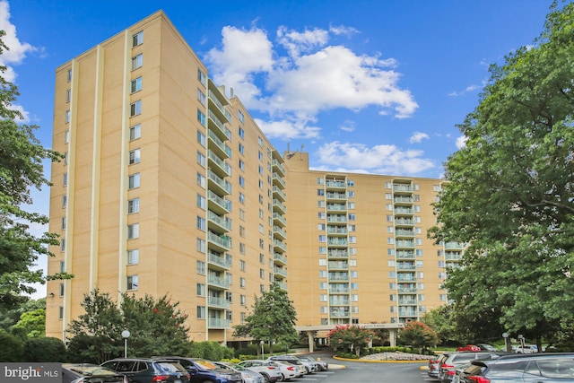 view of apartment building / complex featuring uncovered parking