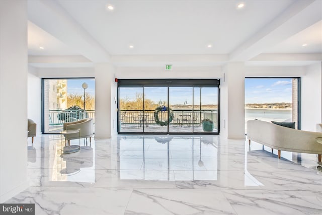 hall with marble tiled floors and recessed lighting