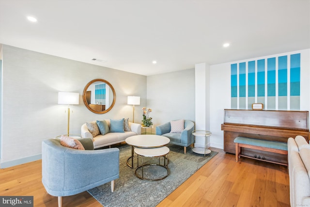 living area with hardwood / wood-style floors, recessed lighting, and baseboards