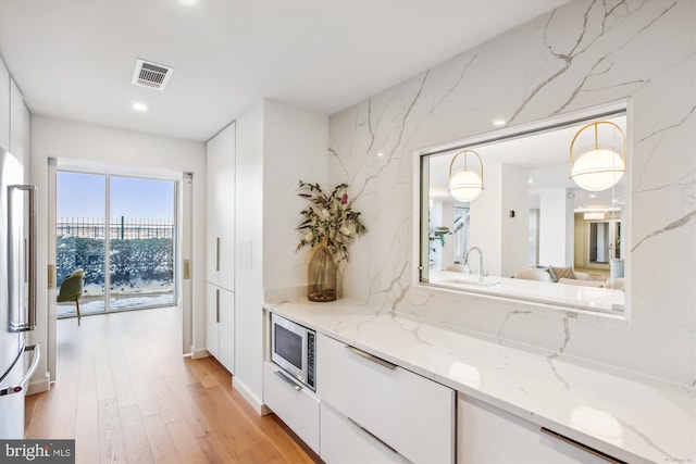 bar area featuring stainless steel appliances, light wood-type flooring, and recessed lighting