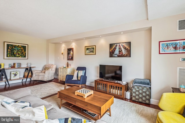 living area featuring wood finished floors, baseboards, and recessed lighting