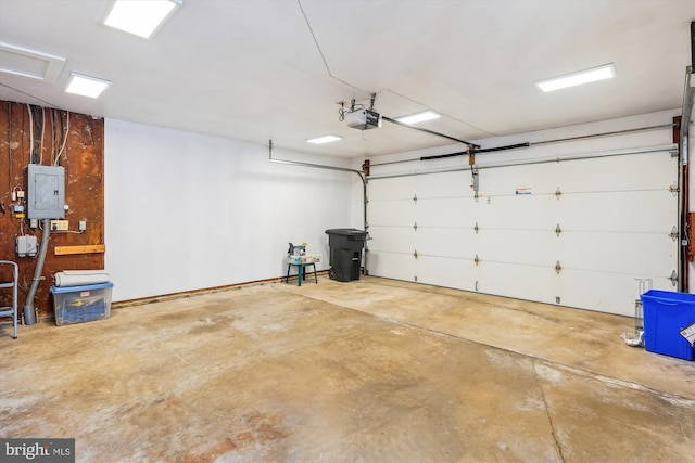 garage featuring electric panel and a garage door opener