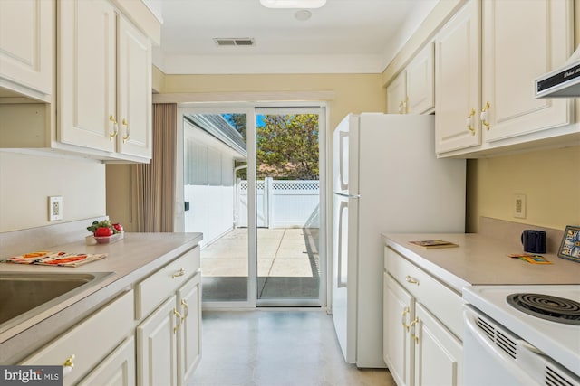 kitchen with light countertops, ventilation hood, and white cabinets