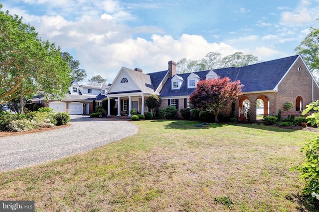 6454 Carmines Island Ln, Hayes, VA 23072 - greek revival inspired property with a chimney, brick siding, gravel driveway, a front lawn, and a garage