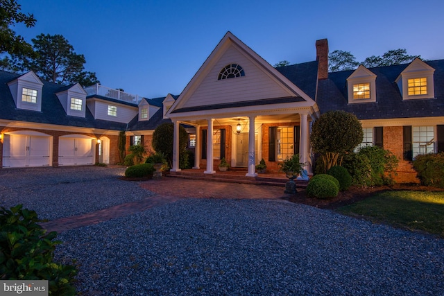6454 Carmines Island Ln, Hayes, VA 23072 - view of front of house with covered porch, brick siding, a chimney, and gravel driveway