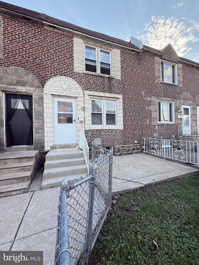 426 S Church St, Clifton Heights, PA 19018 - view of front of property with entry steps, brick siding, and a patio area