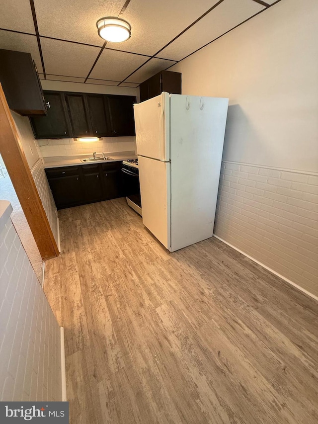 426 S Church St, Clifton Heights, PA 19018 - kitchen featuring range with gas stovetop, freestanding refrigerator, light wood-style floors, a drop ceiling, and light countertops