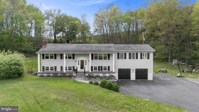 115 Bailey Settlement Hwy, Clearfield, PA 16830 - split foyer home featuring asphalt driveway, a chimney, a garage, and a front lawn