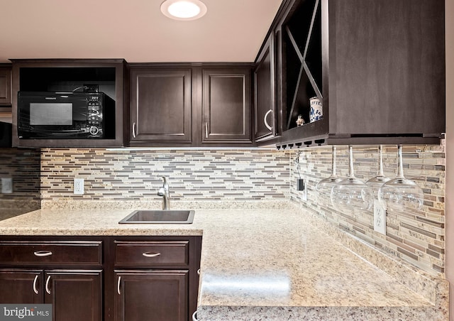 115 Bailey Settlement Hwy, Clearfield, PA 16830 - kitchen featuring a sink, black microwave, dark brown cabinetry, and tasteful backsplash