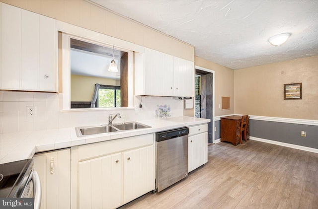 4115 Grandview Rd, Hanover, PA 17331 - kitchen with appliances with stainless steel finishes, a sink, light wood-style flooring, decorative backsplash, and white cabinetry