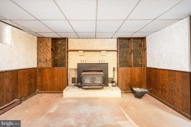 4115 Grandview Rd, Hanover, PA 17331 - unfurnished living room featuring wood walls, a drop ceiling, a wood stove, a wainscoted wall, and baseboard heating